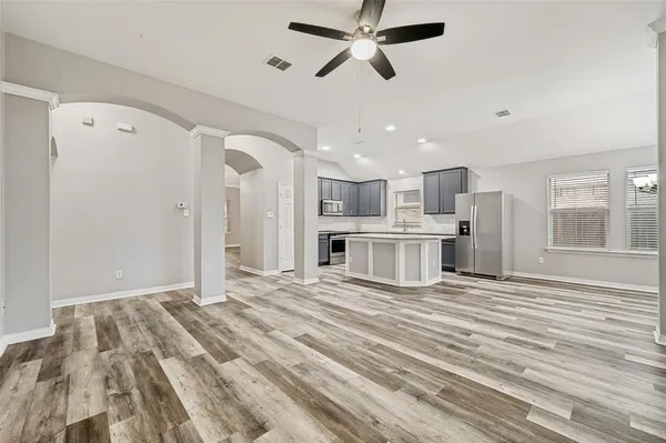 a view of a kitchen with a sink dishwasher stove top oven and cabinets