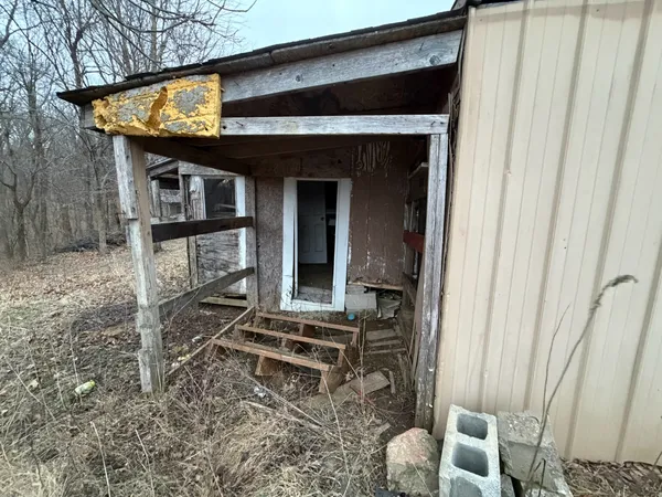 a backyard of a house with table and chairs
