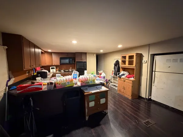 a view of a kitchen with dining table and chairs