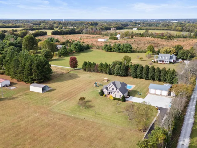 a view of a livingroom with fireplace wooden floor and a window