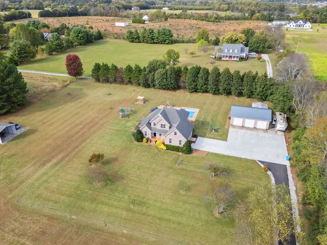 a living room with a fireplace and a floor to ceiling window