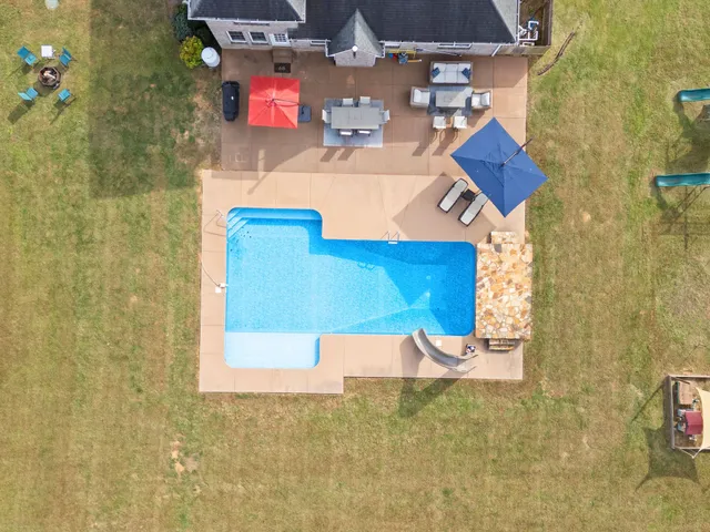a view of staircase with lots of frames on wall and wooden floor