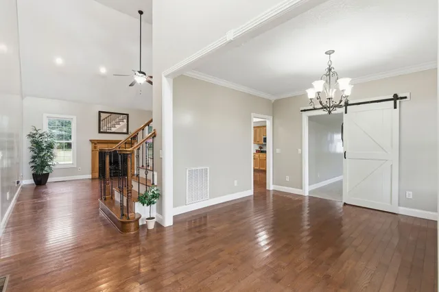a kitchen with stainless steel appliances granite countertop a sink a stove and a refrigerator