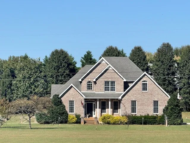 a car parked in front of white house