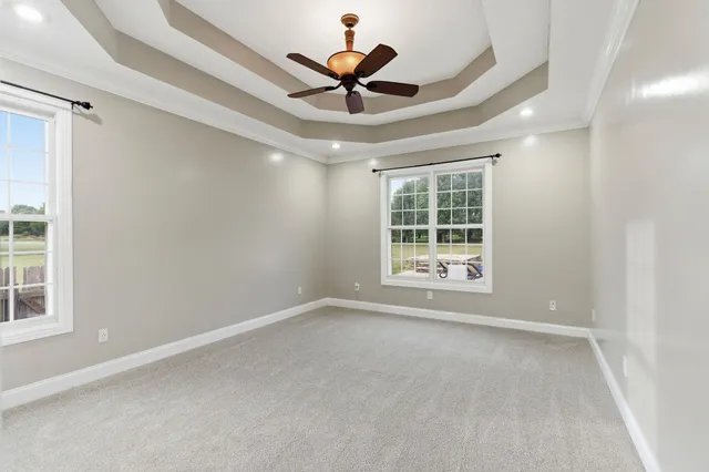 a blue swimming pool with a lawn chairs under an umbrella
