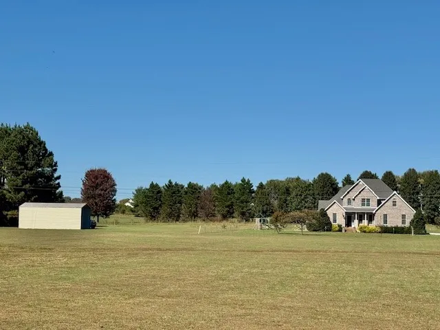 a front view of a house with a lake view