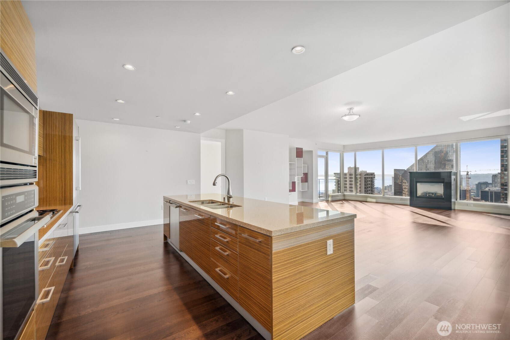1920 4th Avenue, Unit 2301 Seattle, WA 98101 - Photo 11 of 40 a spacious kitchen with stainless steel appliances a sink and a flat screen tv