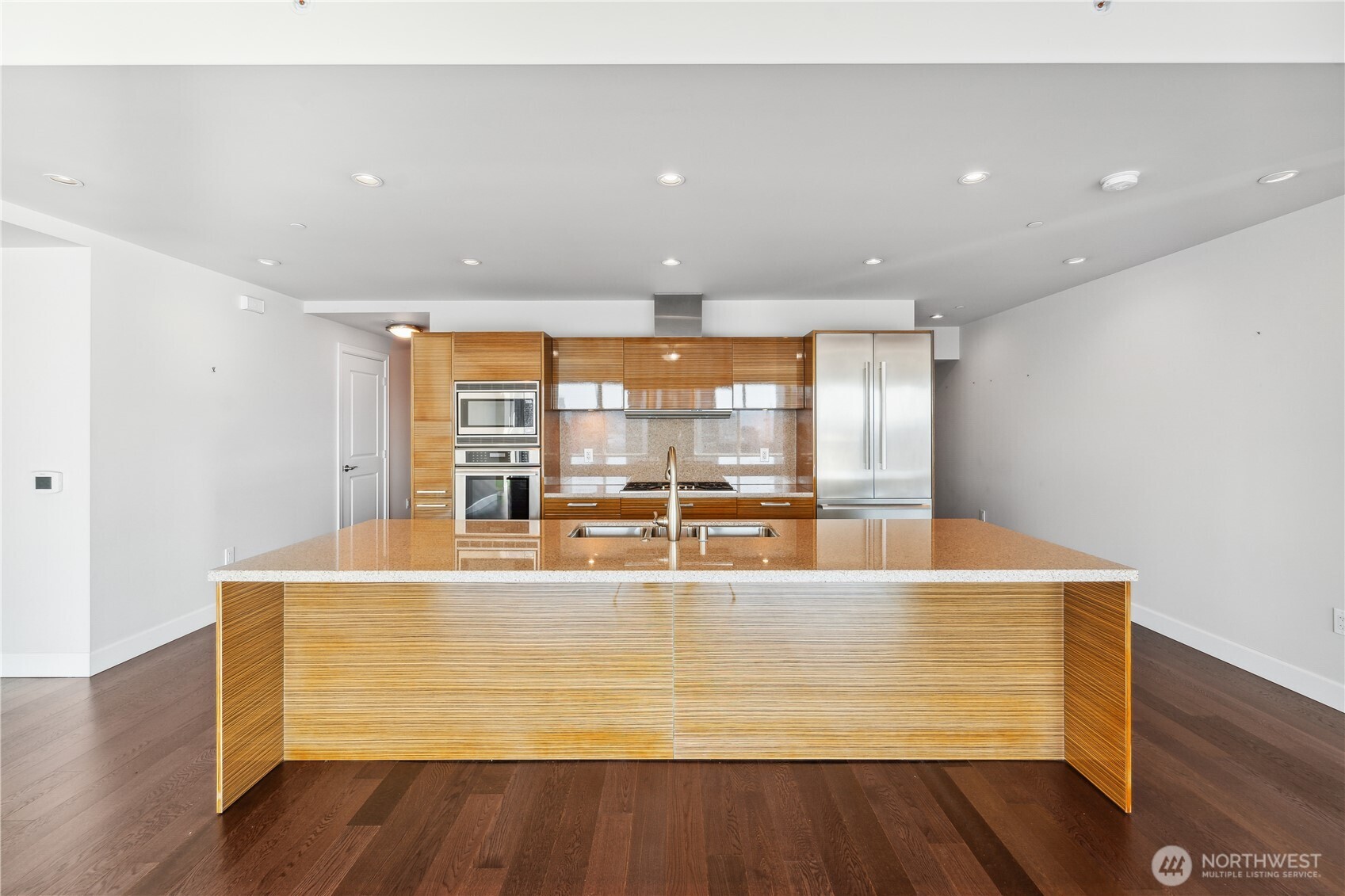1920 4th Avenue, Unit 2301 Seattle, WA 98101 - Photo 12 of 40 a large white kitchen with wooden floor