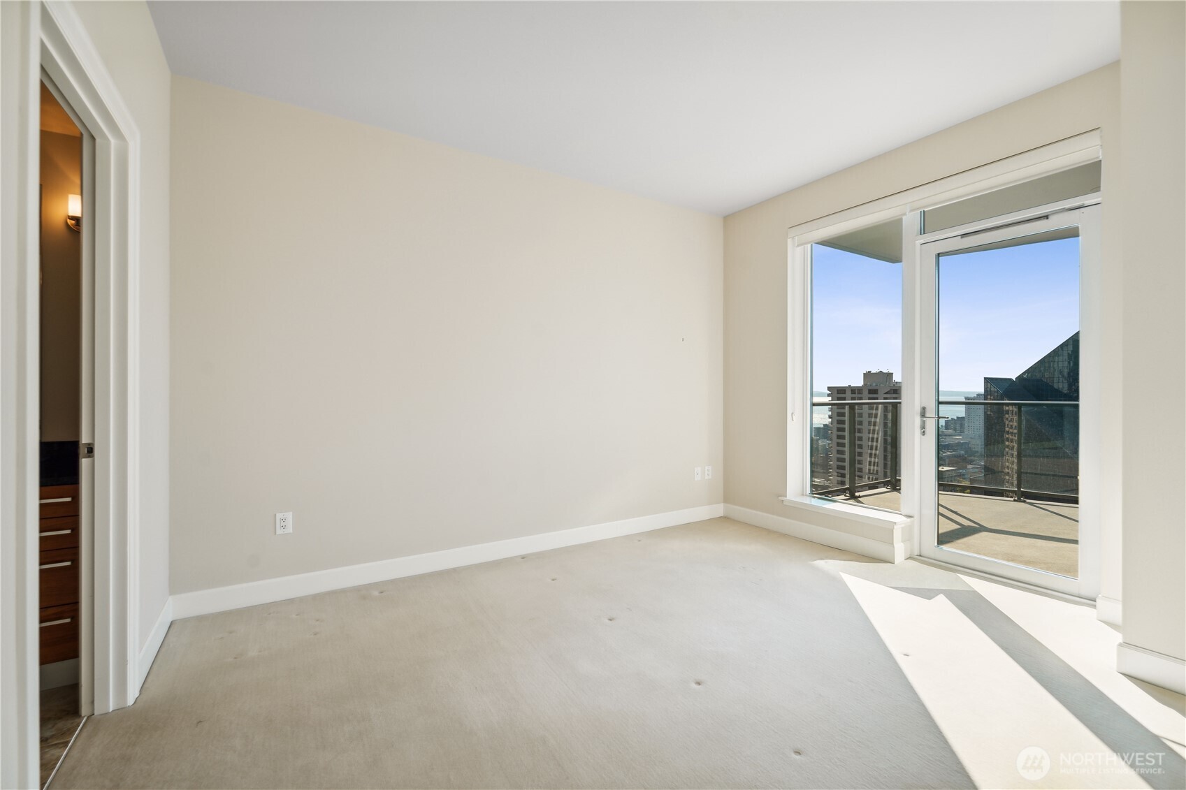 1920 4th Avenue, Unit 2301 Seattle, WA 98101 - Photo 21 of 40 an empty room with sliding door
