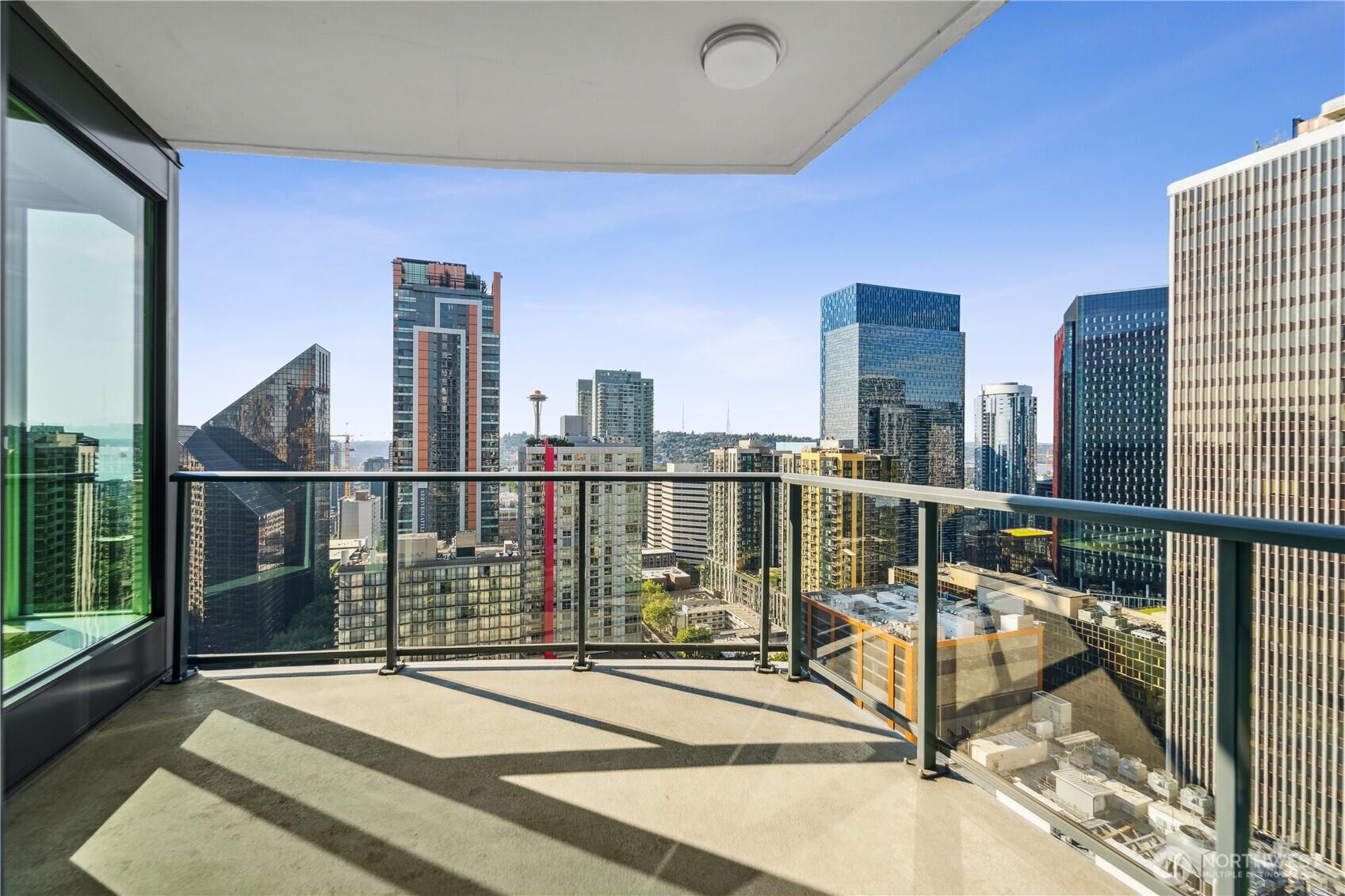 1920 4th Avenue, Unit 2301 Seattle, WA 98101 - Photo 27 of 40 a view of balcony with two chairs and a table