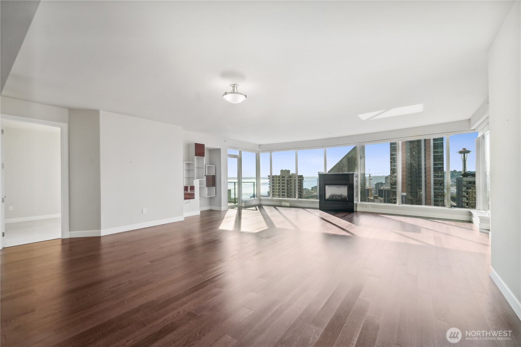 1920 4th Avenue, Unit 2301 Seattle, WA 98101 - Photo 3 of 40 a view of a room with wooden floor and glass door