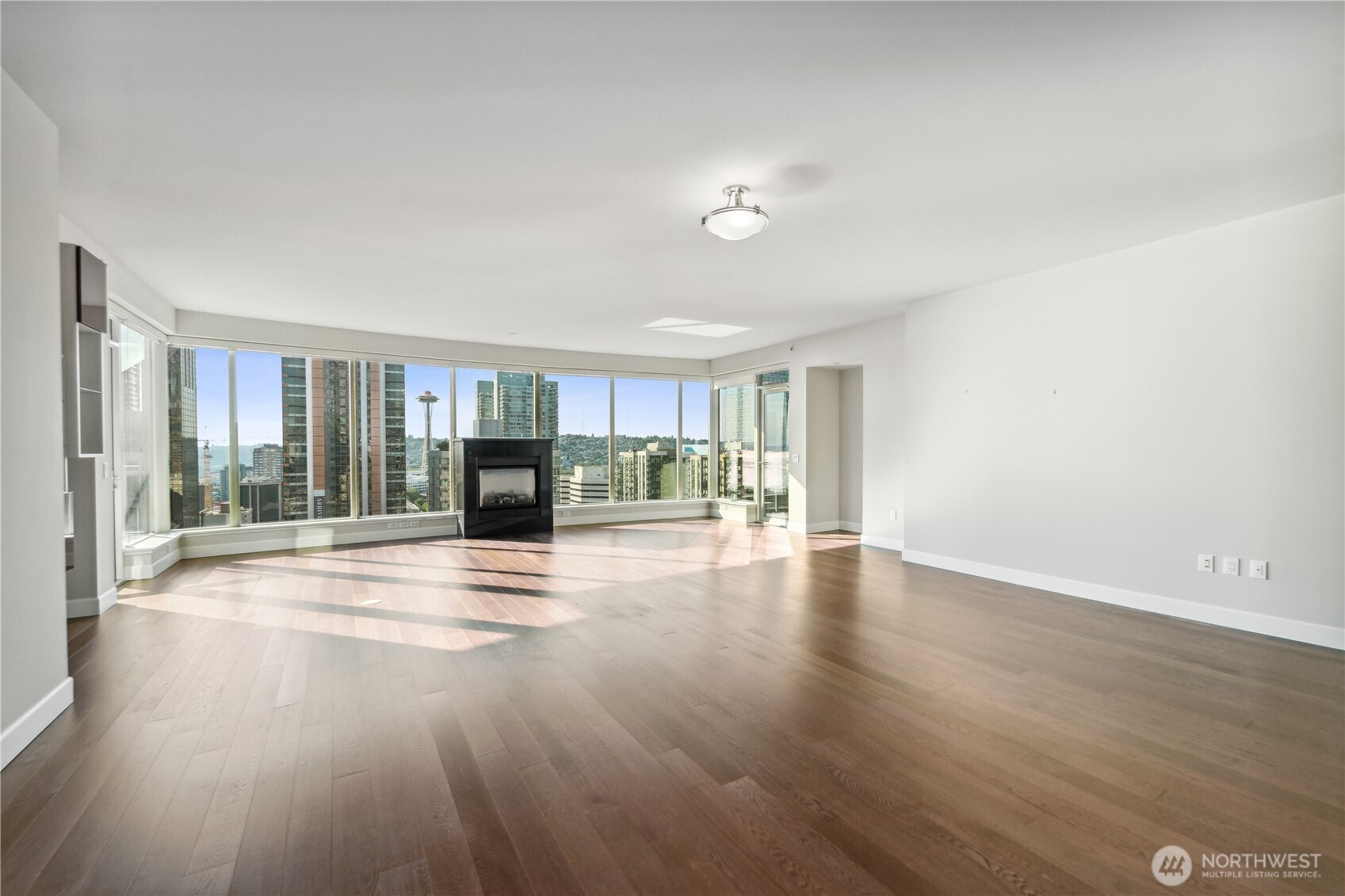 1920 4th Avenue, Unit 2301 Seattle, WA 98101 - Photo 4 of 40 a view of empty room with wooden floor and fan