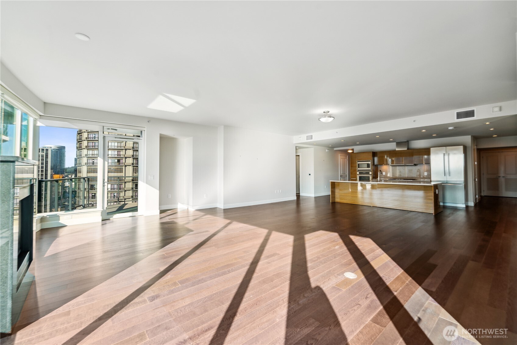 1920 4th Avenue, Unit 2301 Seattle, WA 98101 - Photo 6 of 40 a living room with hardwood floor and a large window