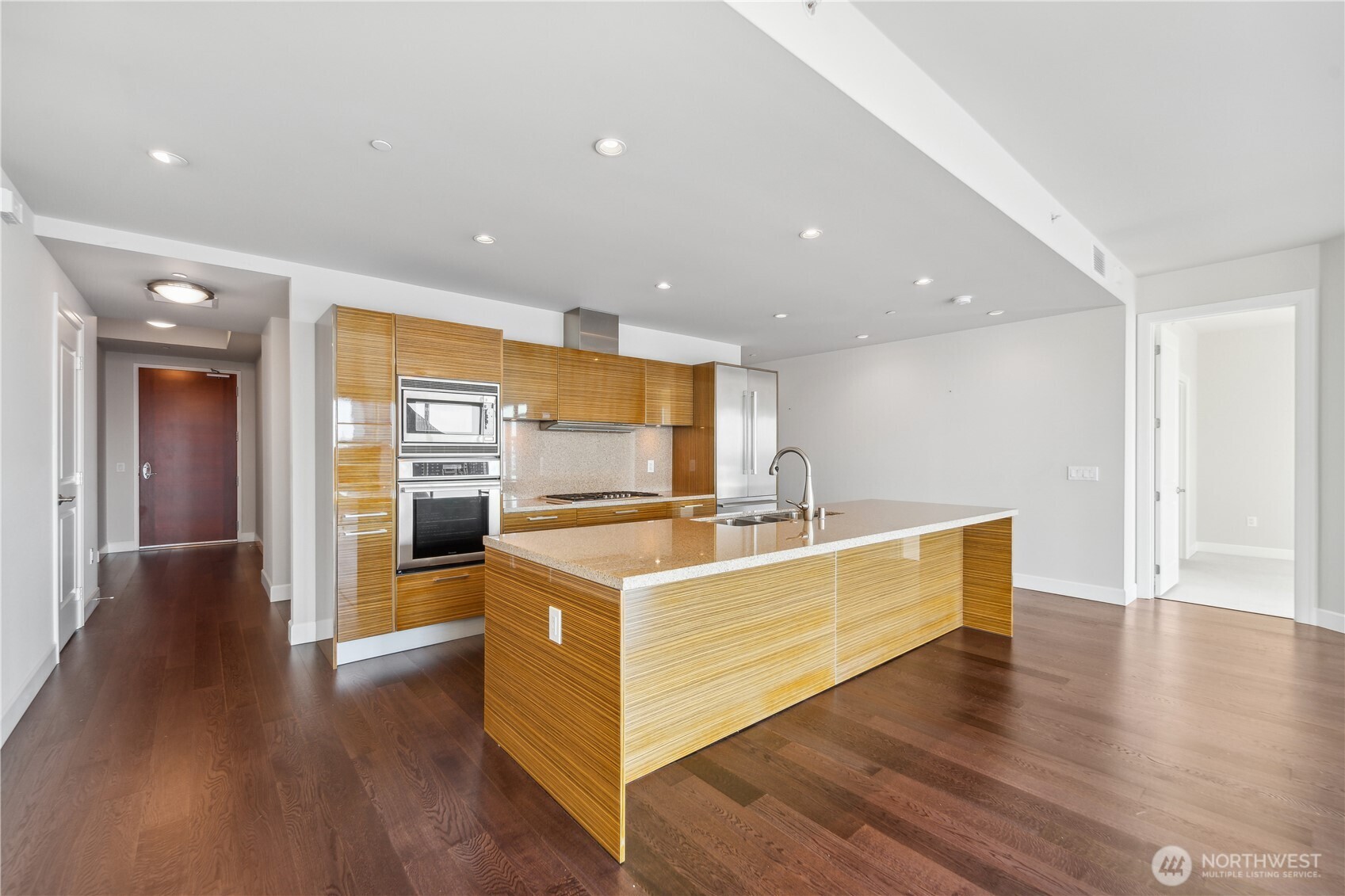 1920 4th Avenue, Unit 2301 Seattle, WA 98101 - Photo 10 of 40 a view of a kitchen with wooden floor