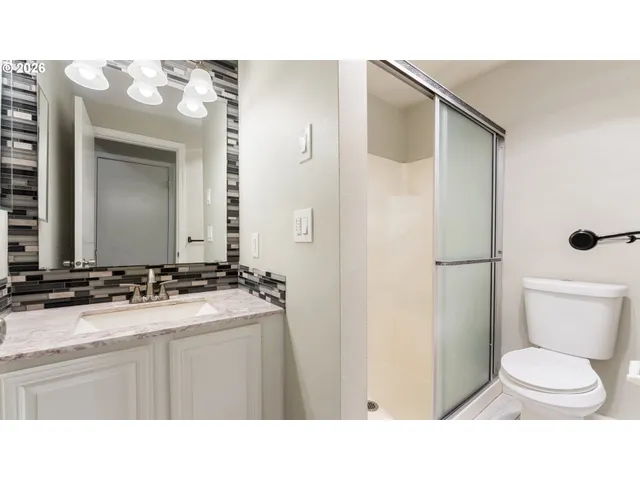 a view of bathroom with a window and a mirror