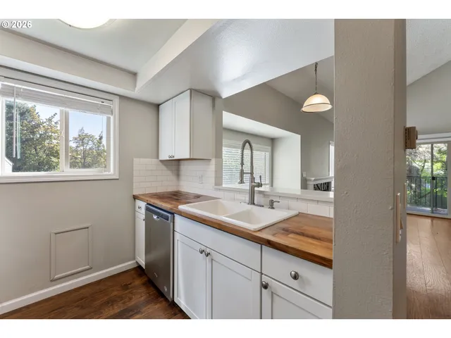 a kitchen with a sink cabinets and a window