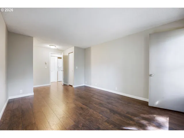 a view of an empty room and wooden floor