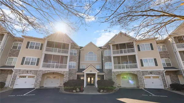 a front view of a residential apartment building with a yard