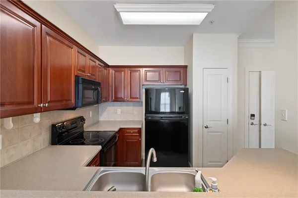 a kitchen with a refrigerator and a sink