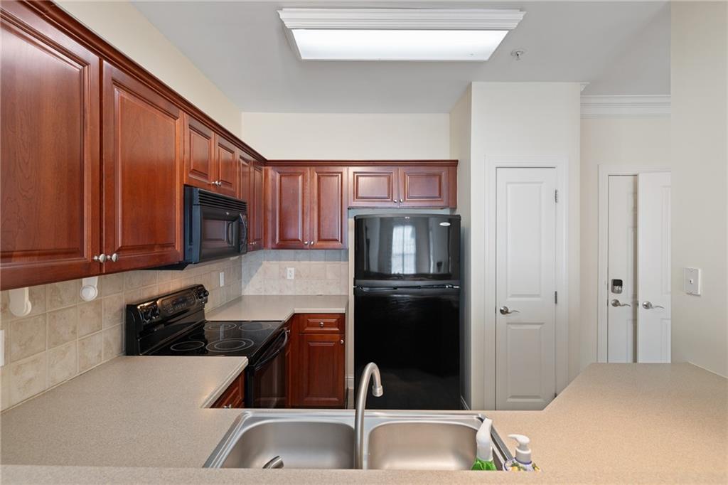 3309 Village Boulevard Southeast Rome, GA 30161 - Photo 11 of 38 a kitchen with a refrigerator and a sink