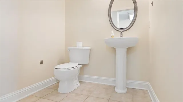 a bathroom with a sink toilet and a mirror