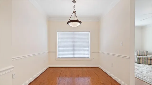 a view of a room with wooden floor and windows