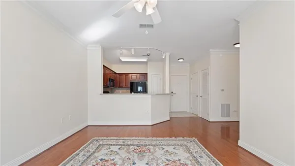 a view of an empty room and wooden floor
