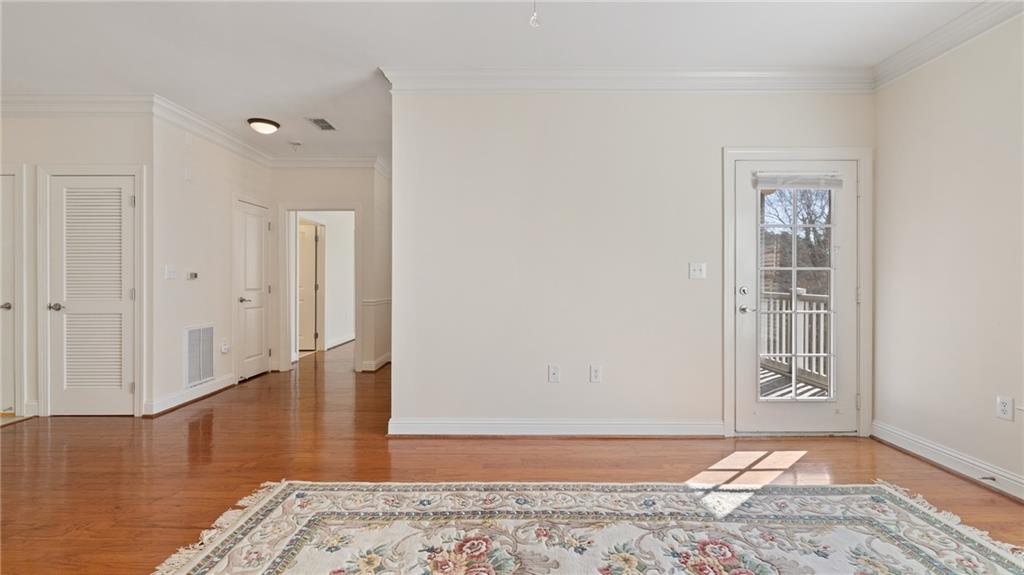 3309 Village Boulevard Southeast Rome, GA 30161 - Photo 4 of 38 a view of an empty room with wooden floor and a window