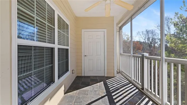 a view of a balcony with wooden floor and fence