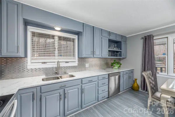 a kitchen with a sink window and cabinets