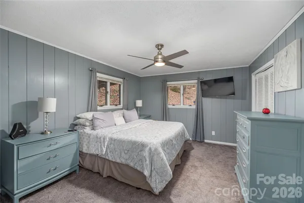 a bedroom with a large bed and a window