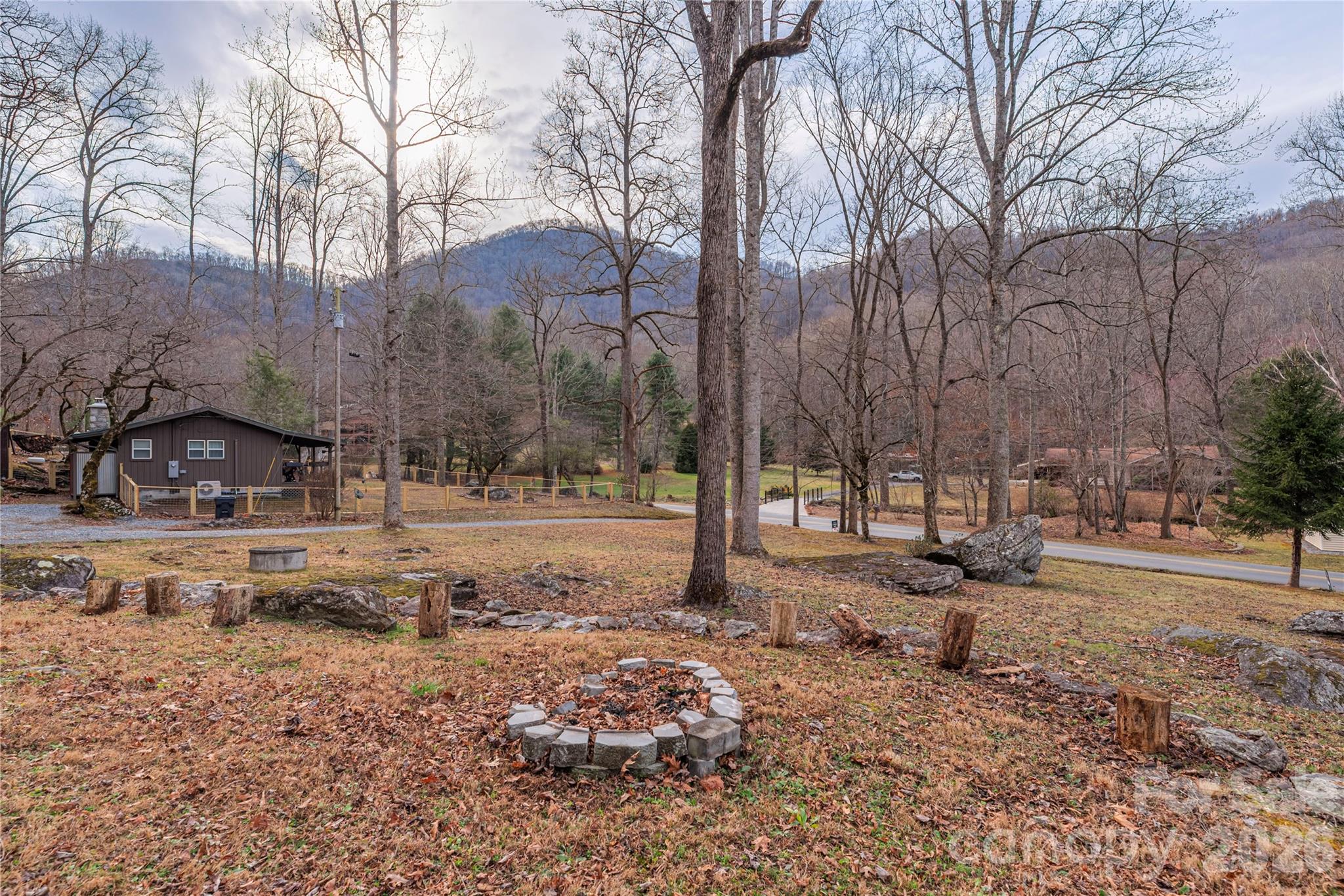 3415 Conleys Creek Road Whittier, NC 28789 - Photo 24 of 27 a view of a yard covered with snow in the road