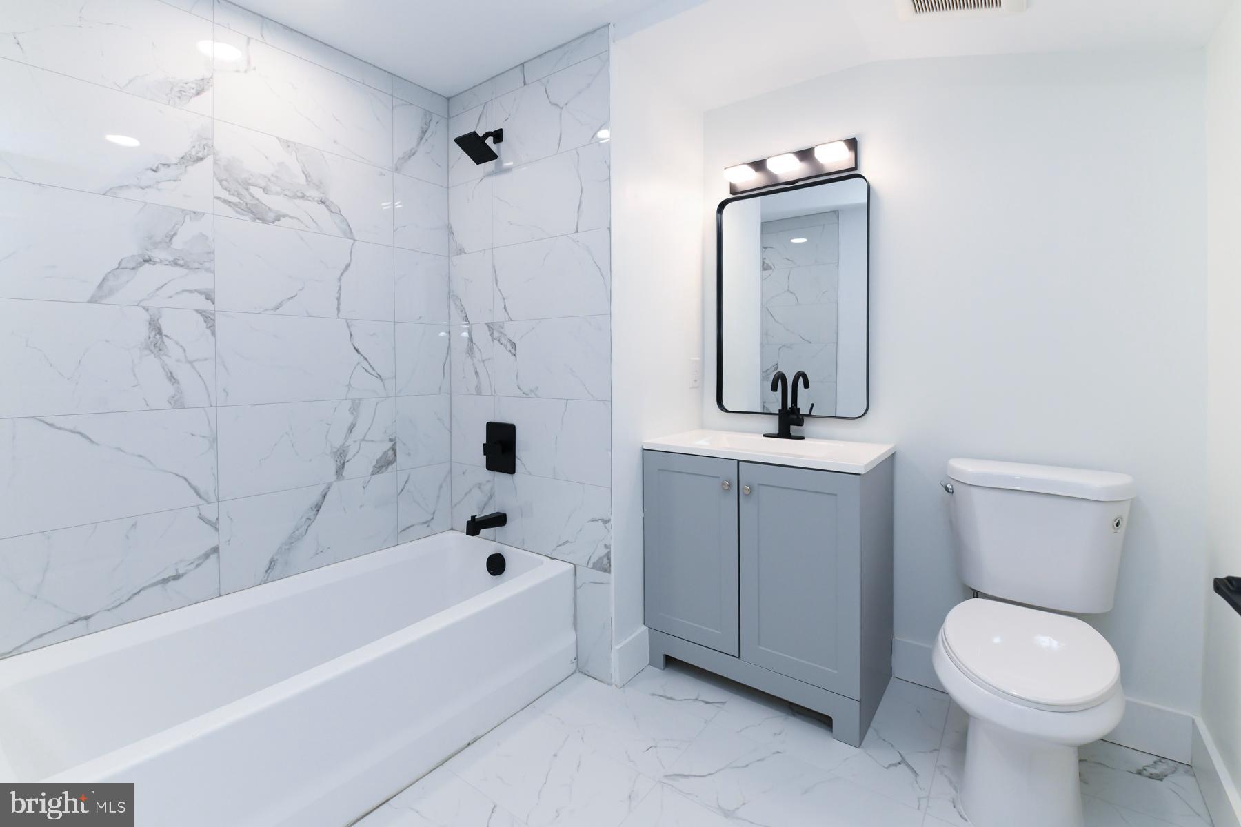 100 Aura Road, Unit 212 Clayton, NJ 08312 - Photo 14 of 19 a bathroom with a toilet sink and mirror