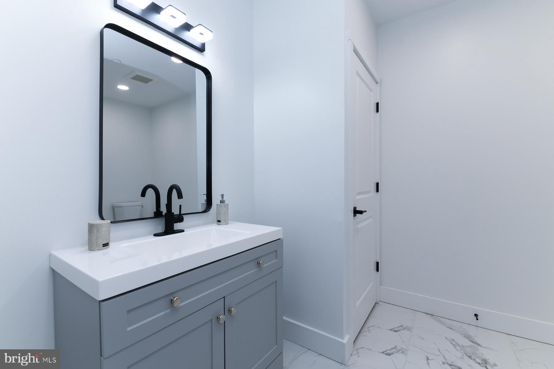 100 Aura Road, Unit 212 Clayton, NJ 08312 - Photo 15 of 19 a bathroom with a sink and mirror