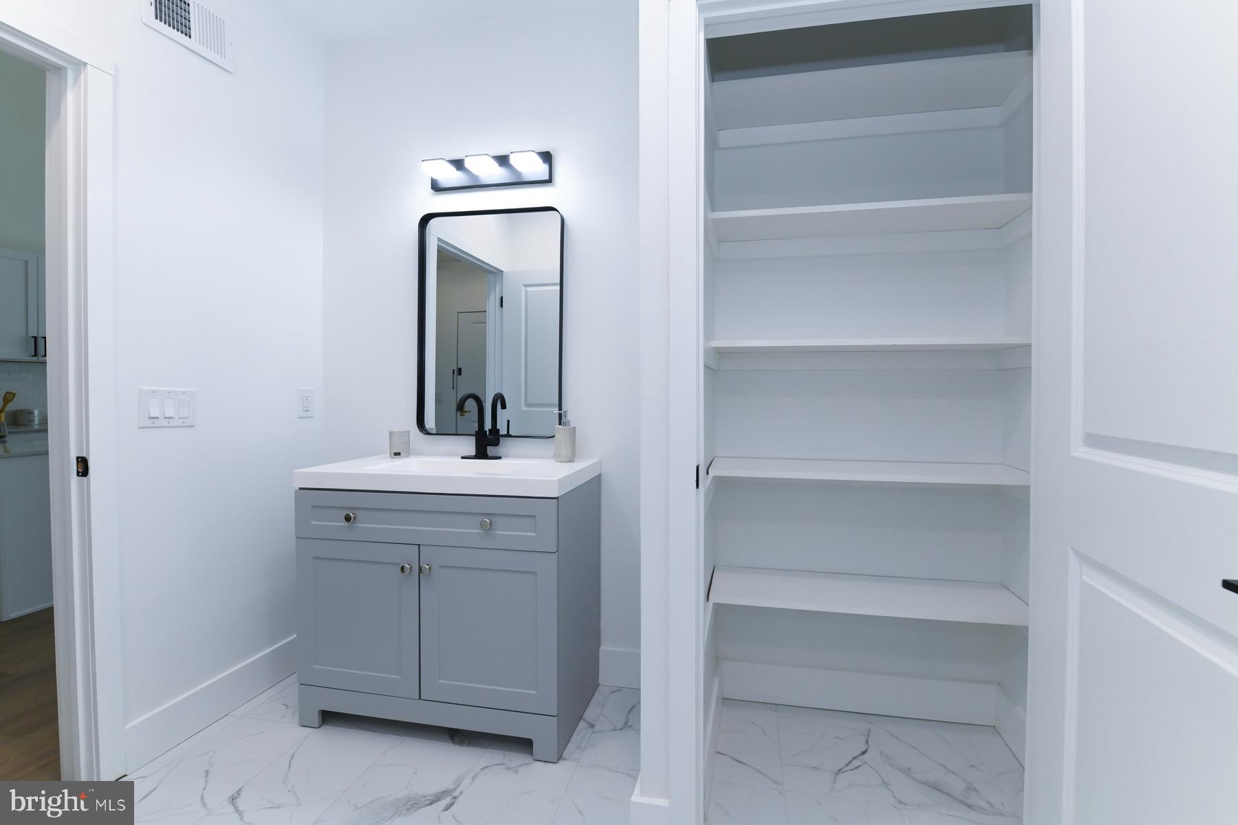 100 Aura Road, Unit 212 Clayton, NJ 08312 - Photo 16 of 19 a bathroom with a sink and a mirror