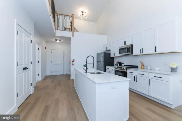a kitchen with cabinets a sink and appliances