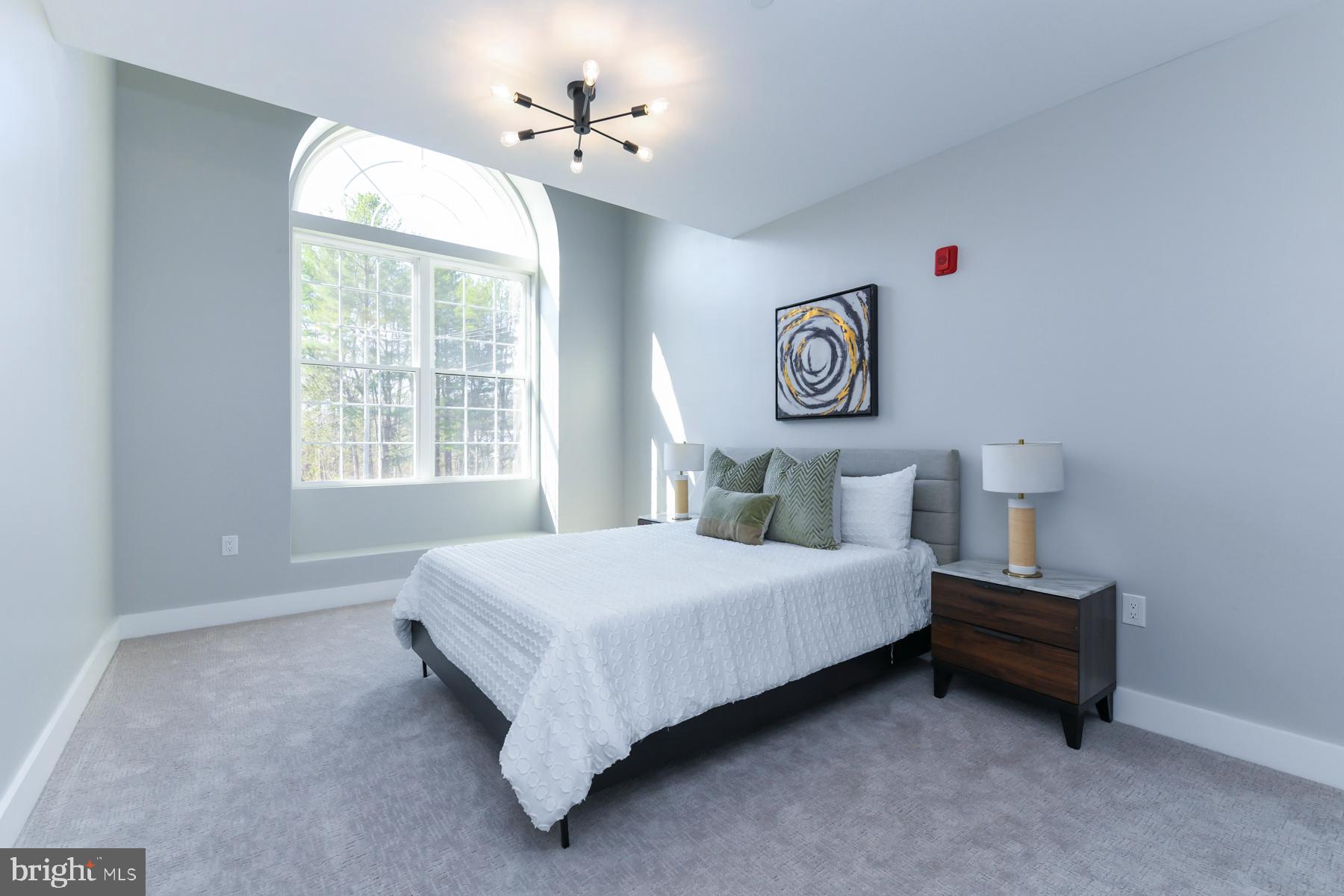 100 Aura Road, Unit 212 Clayton, NJ 08312 - Photo 10 of 19 a bedroom with a bed and a window