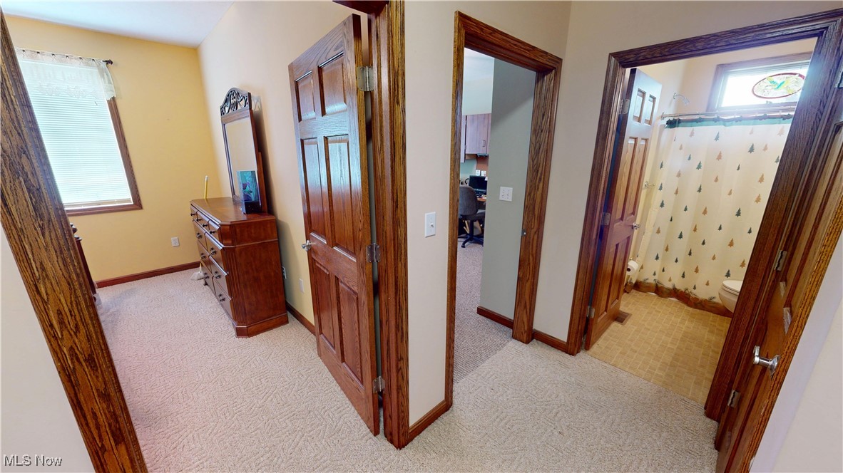 10323 Smith Road Litchfield, OH 44253 - Photo 32 of 50 Hallway with baseboards and light colored carpet