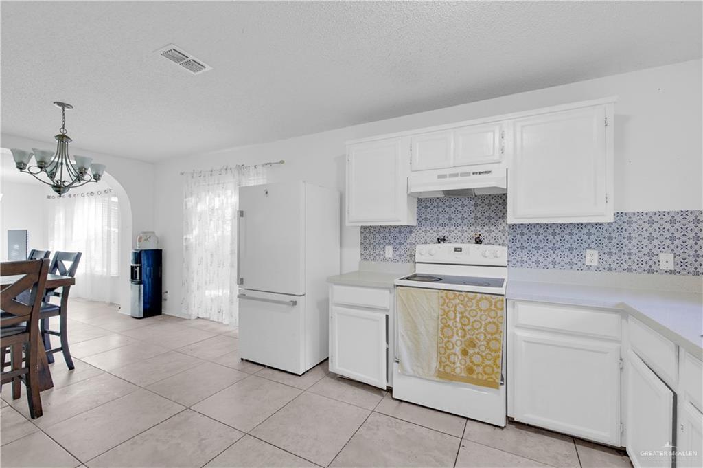 3301 Princeton Avenue McAllen, TX 78504 - Photo 12 of 21 a kitchen with a stove a sink and a refrigerator