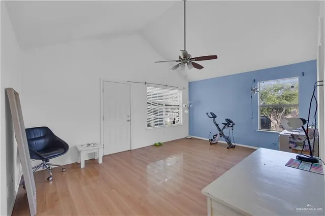 a view of a workspace with furniture and a window