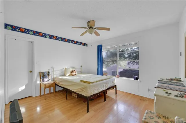 a living room with a table chairs and a wooden floor