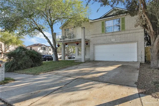 a view of a house with a yard and garage