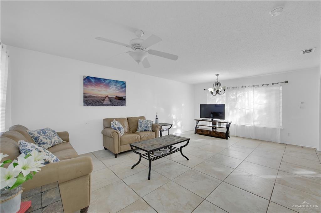 3301 Princeton Avenue McAllen, TX 78504 - Photo 6 of 21 a living room with furniture and a dining table with kitchen appliances