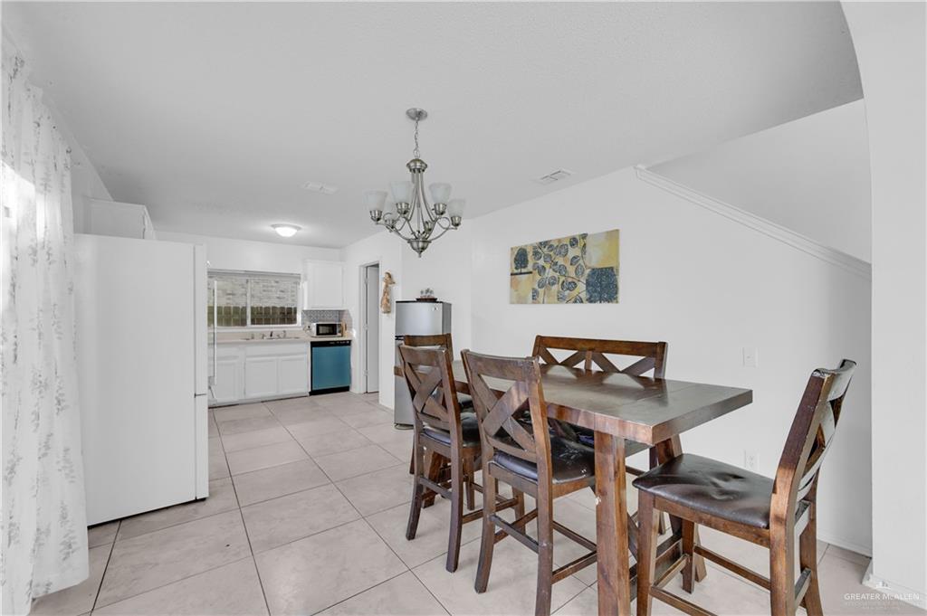 3301 Princeton Avenue McAllen, TX 78504 - Photo 8 of 21 a view of a dining room with furniture and chandelier