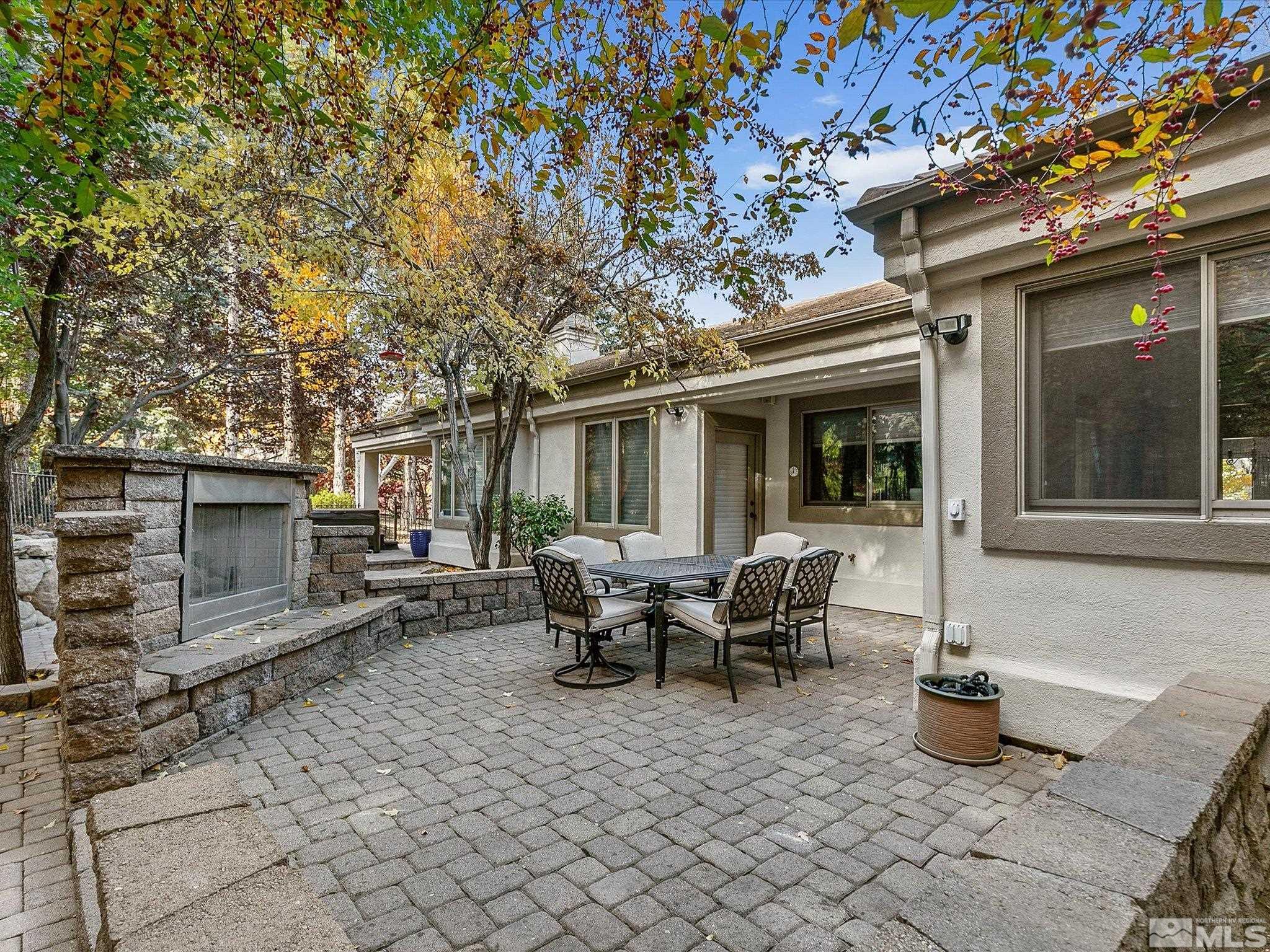 100 Sawbuck Road Reno, NV 89519 - Photo 12 of 40 a view of a patio with table and chairs and wooden fence