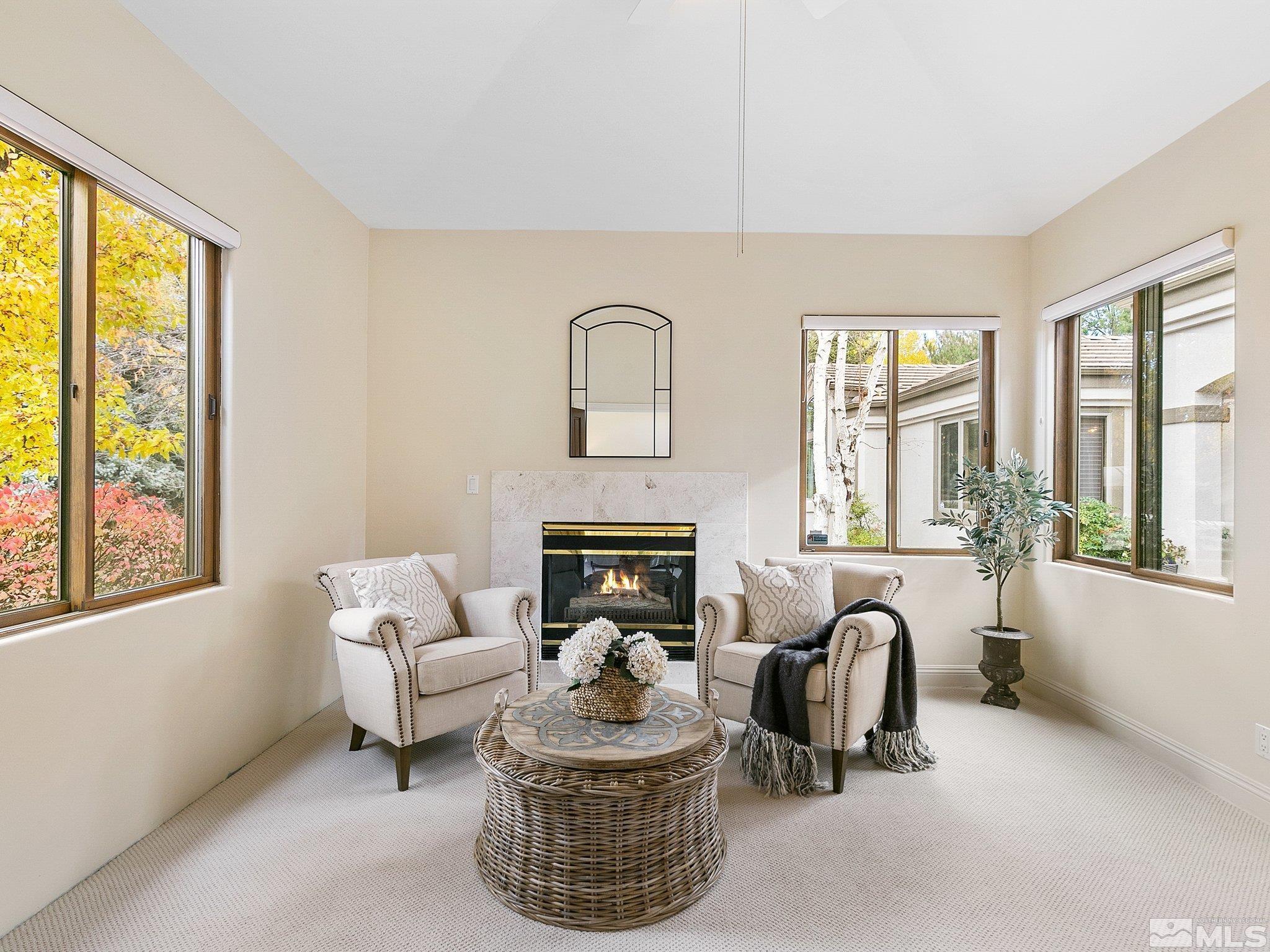 100 Sawbuck Road Reno, NV 89519 - Photo 21 of 40 a living room with furniture a fireplace and a large window