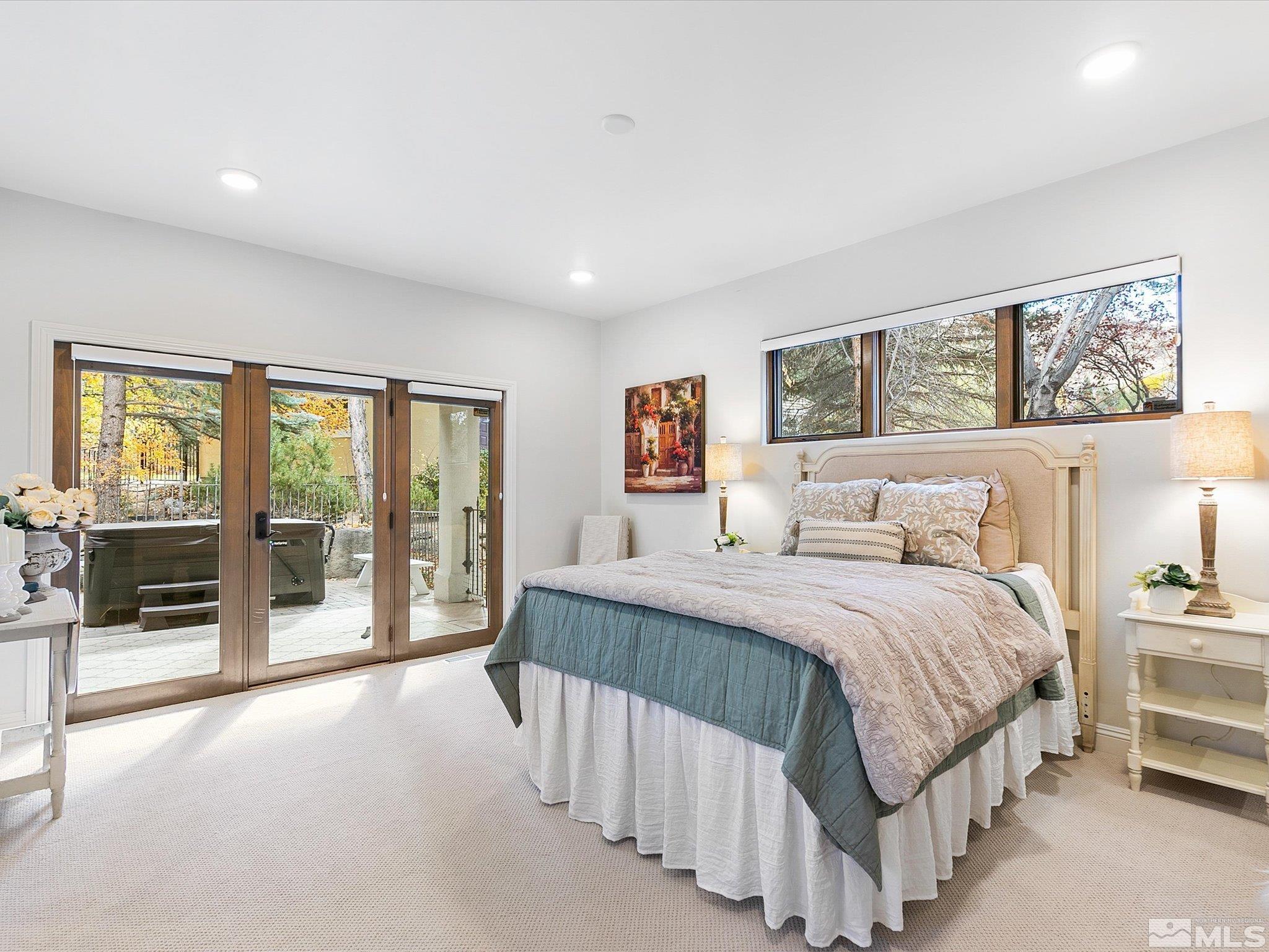 100 Sawbuck Road Reno, NV 89519 - Photo 26 of 40 a spacious bedroom with a large bed and a large window