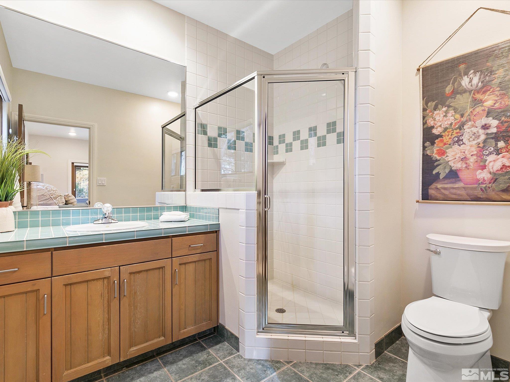 100 Sawbuck Road Reno, NV 89519 - Photo 27 of 40 a bathroom with a granite countertop sink toilet and shower