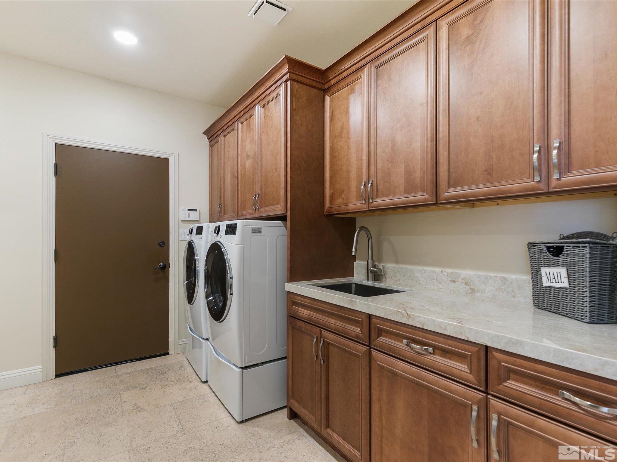 100 Sawbuck Road Reno, NV 89519 - Photo 32 of 40 a kitchen with stainless steel appliances granite countertop a refrigerator and a sink