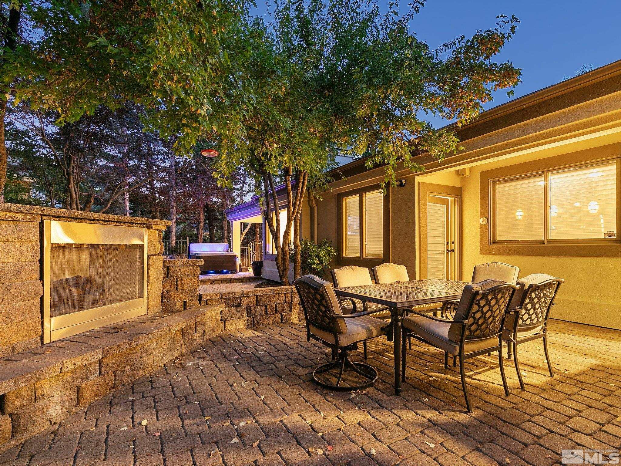 100 Sawbuck Road Reno, NV 89519 - Photo 34 of 40 a view of a patio with table and chairs with wooden floor and fence
